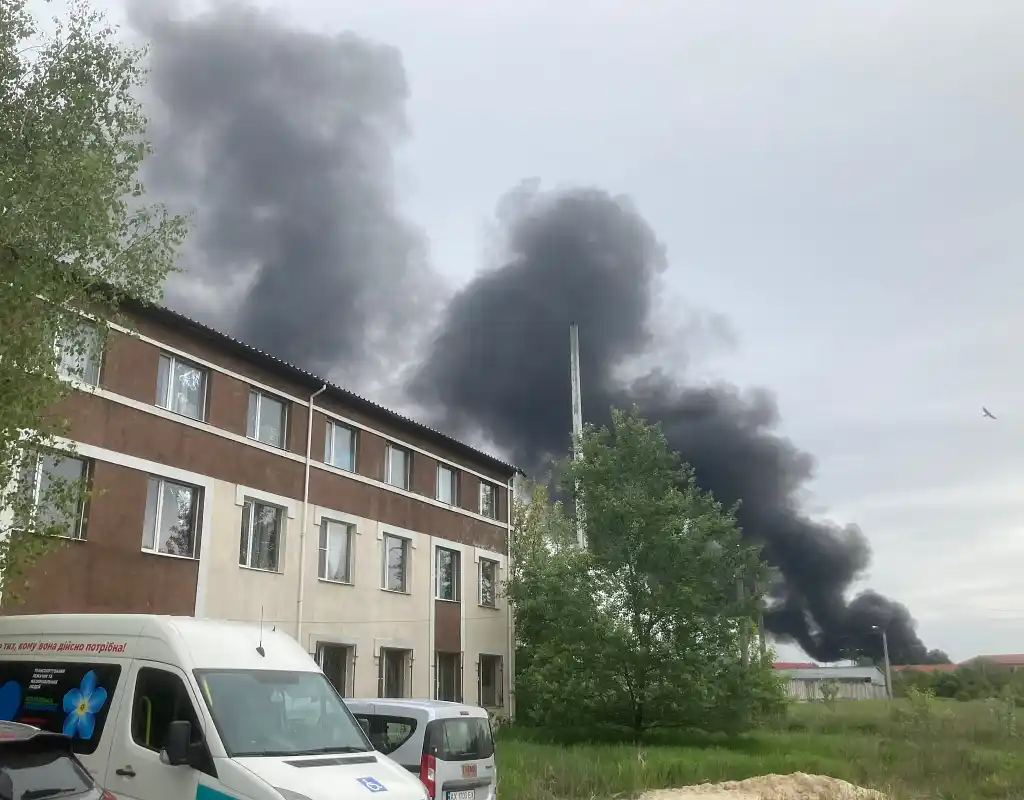 Smoke rises behind the old people's home after an air strike